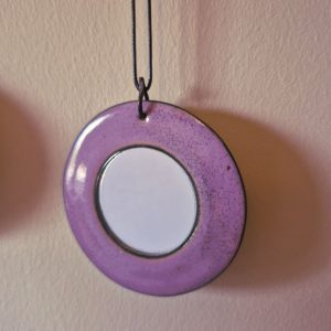 Round mirror with mauve enamel frame